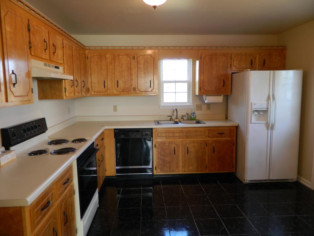 111 Miranda Road Cadiz, KY 42211 - Photo 6 of 15 a kitchen with stainless steel appliances a refrigerator a sink a stove and white cabinets