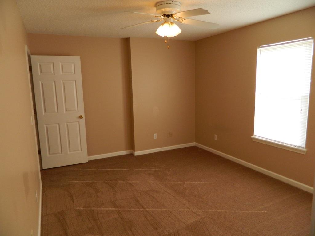 111 Miranda Road Cadiz, KY 42211 - Photo 8 of 15 en empty room with windows and chandelier fan