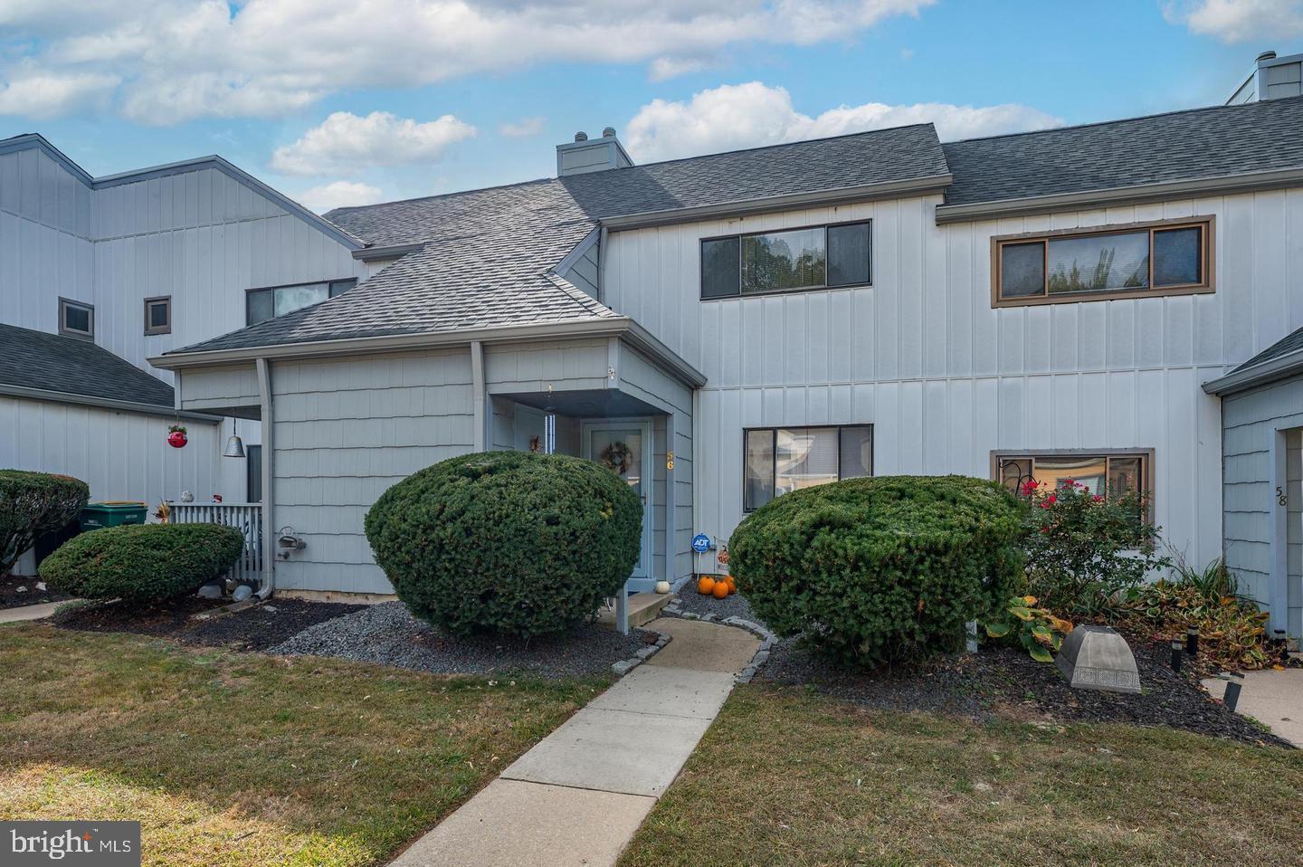 a view of a house with a garden and a yard