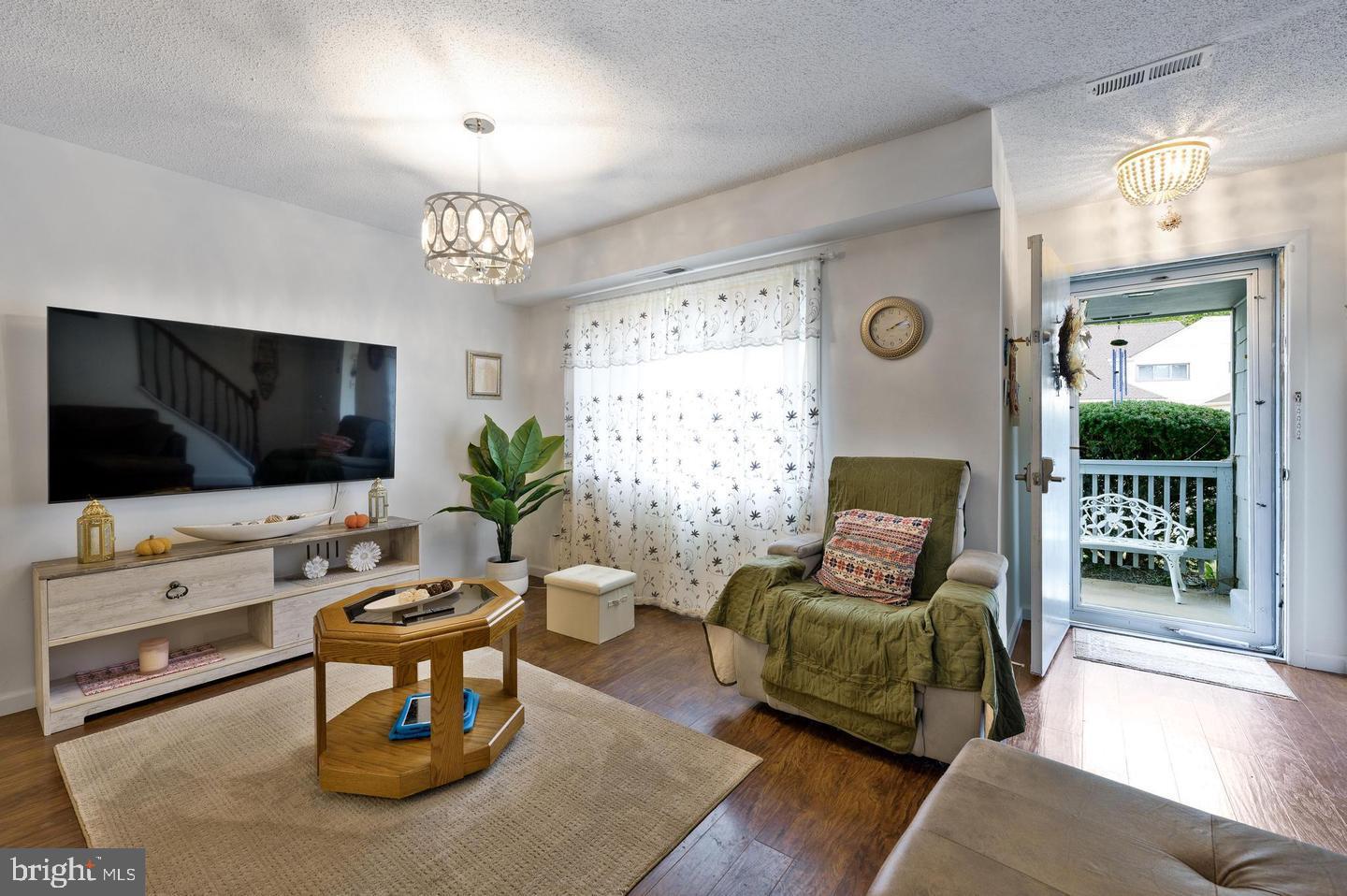 56 Dover Drive Lindenwold, NJ 08021 - Photo 2 of 13 a living room with furniture a flat screen tv and a large window
