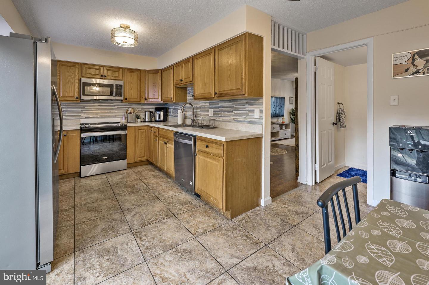 56 Dover Drive Lindenwold, NJ 08021 - Photo 5 of 13 a kitchen with stainless steel appliances granite countertop a refrigerator stove top oven and sink