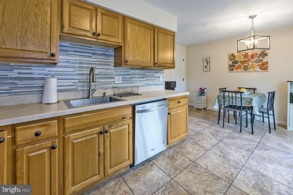 a kitchen with cabinets and chairs