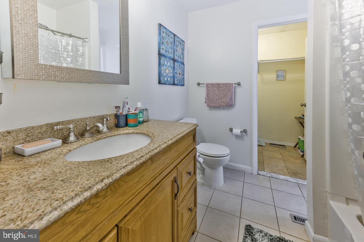 56 Dover Drive Lindenwold, NJ 08021 - Photo 8 of 13 a bathroom with a granite countertop sink a toilet and a shower