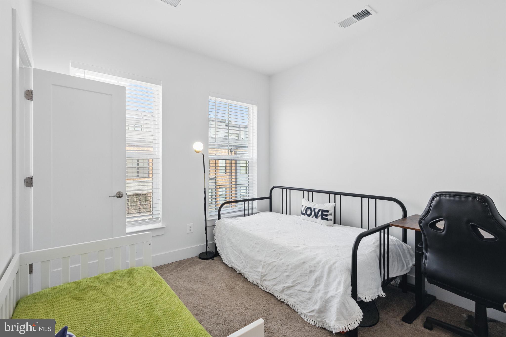 11239 Beaker Street Reston, VA 20190 - Photo 15 of 22 a bedroom with a bed and window