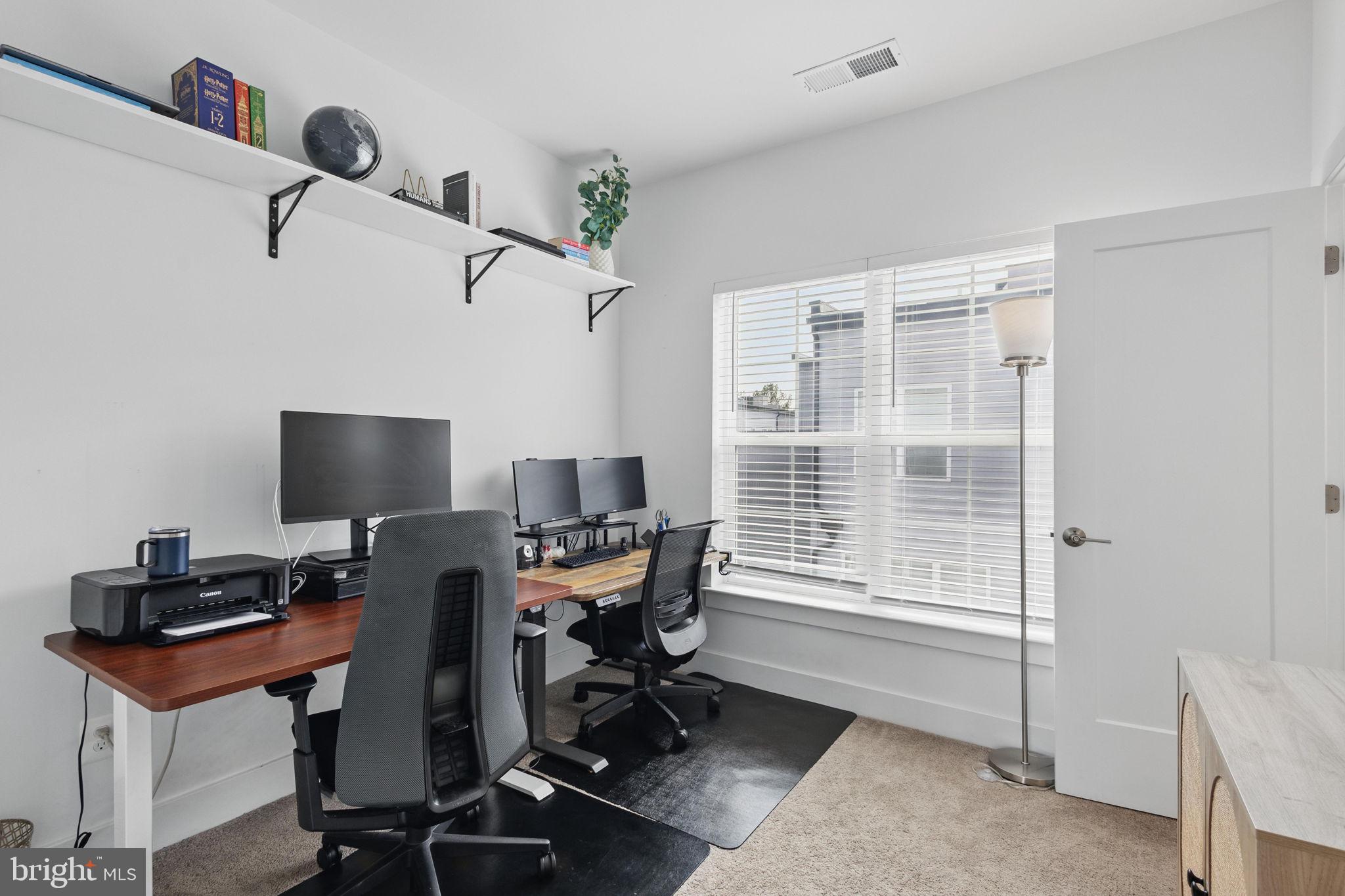 11239 Beaker Street Reston, VA 20190 - Photo 17 of 22 a view of a workspace with furniture and a window