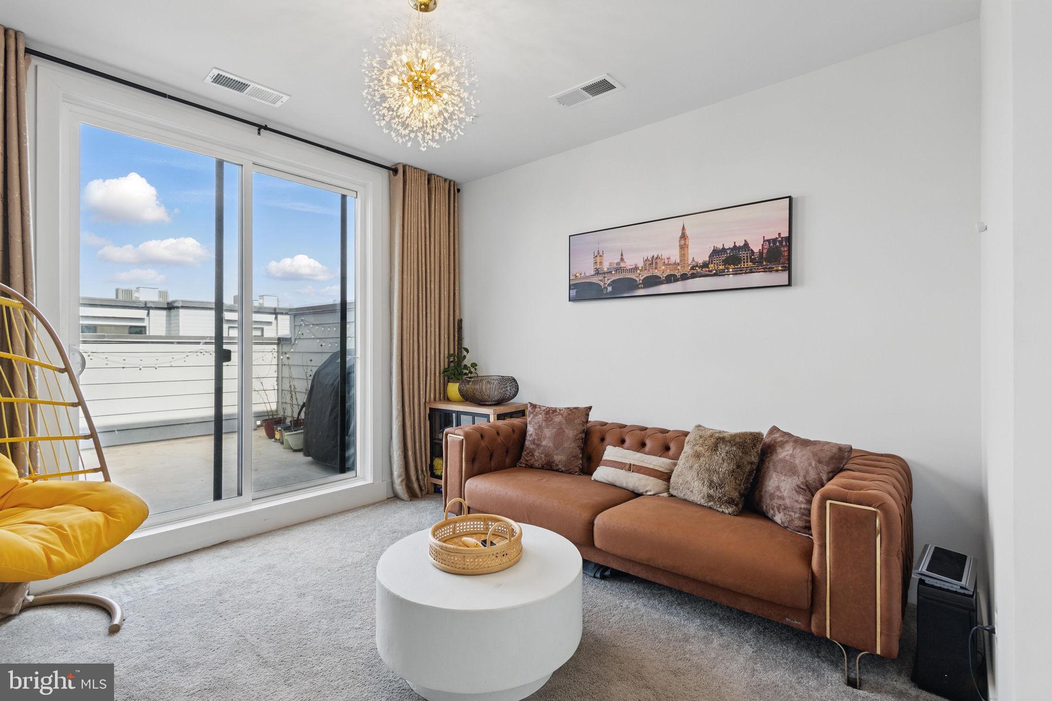 11239 Beaker Street Reston, VA 20190 - Photo 19 of 22 a living room with furniture and a large window