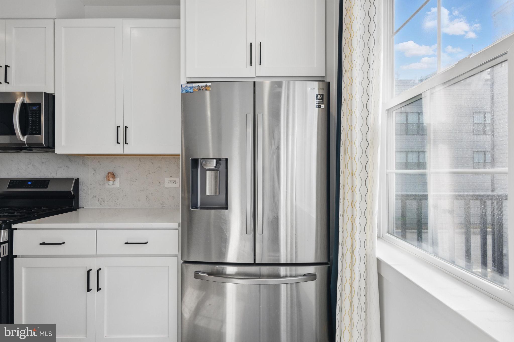 11239 Beaker Street Reston, VA 20190 - Photo 8 of 22 a white refrigerator freezer sitting in a kitchen