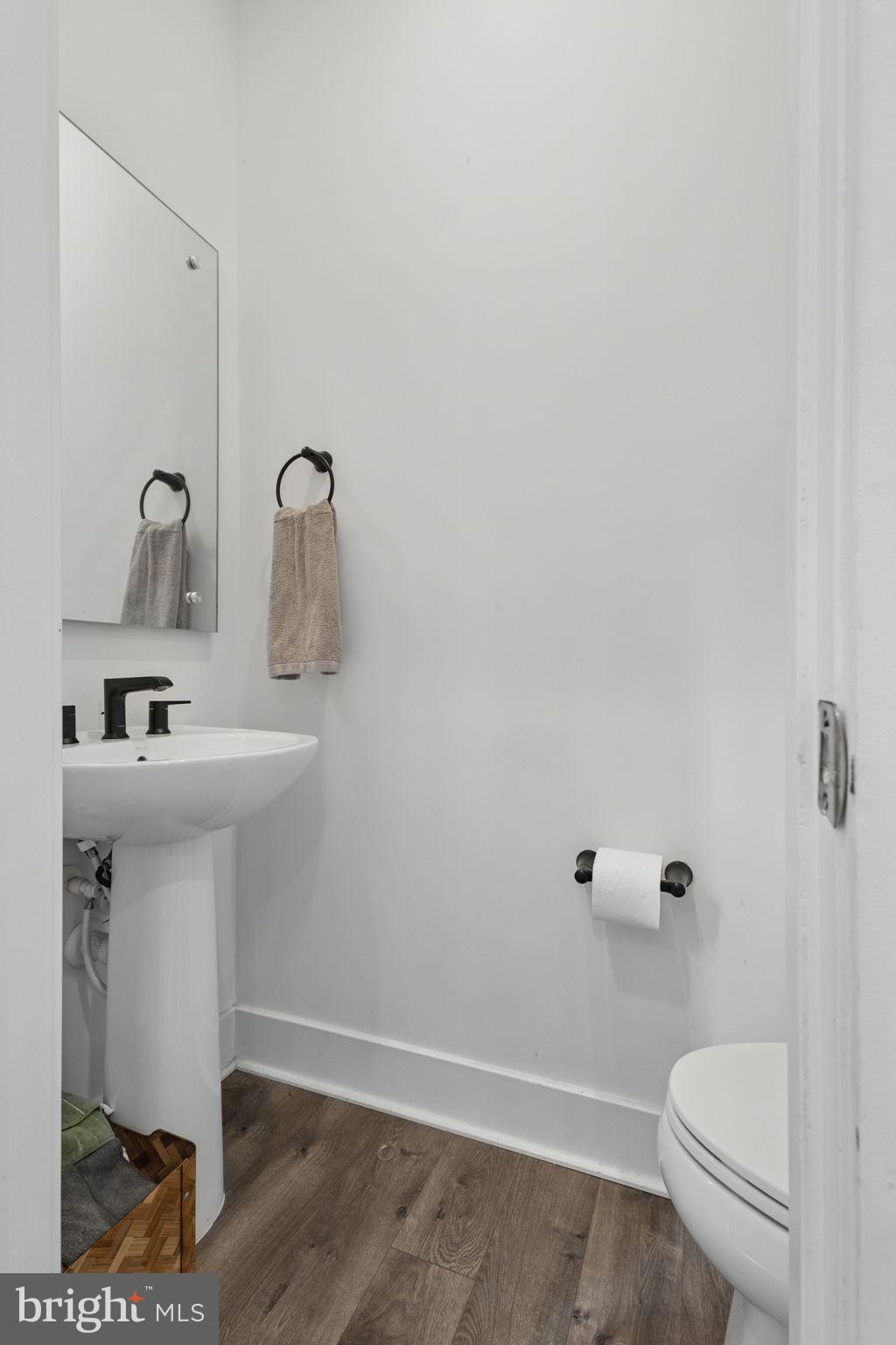 11239 Beaker Street Reston, VA 20190 - Photo 10 of 22 a bathroom with a sink a toilet and shower