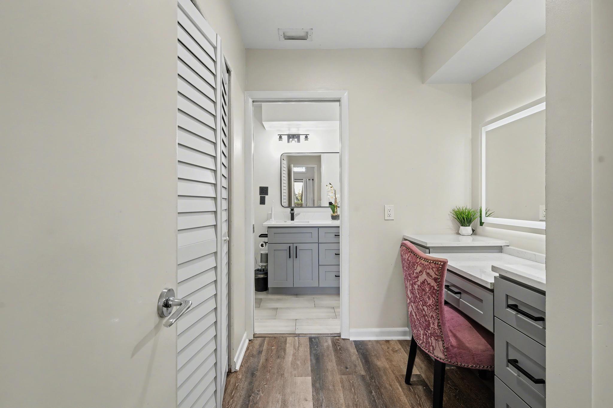 7855 Stanway Place Boca Raton, FL 33433 - Photo 13 of 25 a hallway with a sink and a mirror
