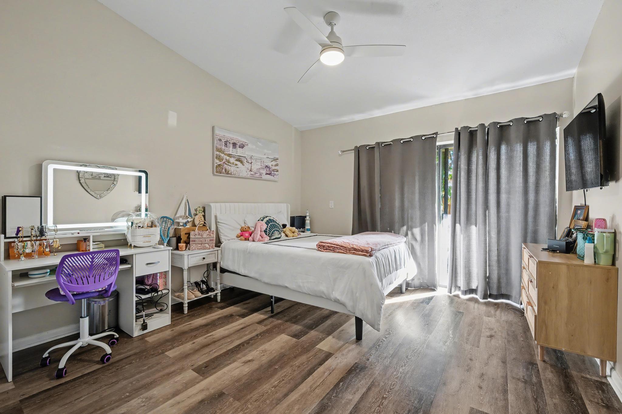 7855 Stanway Place Boca Raton, FL 33433 - Photo 16 of 25 a bedroom with furniture and a wooden floor