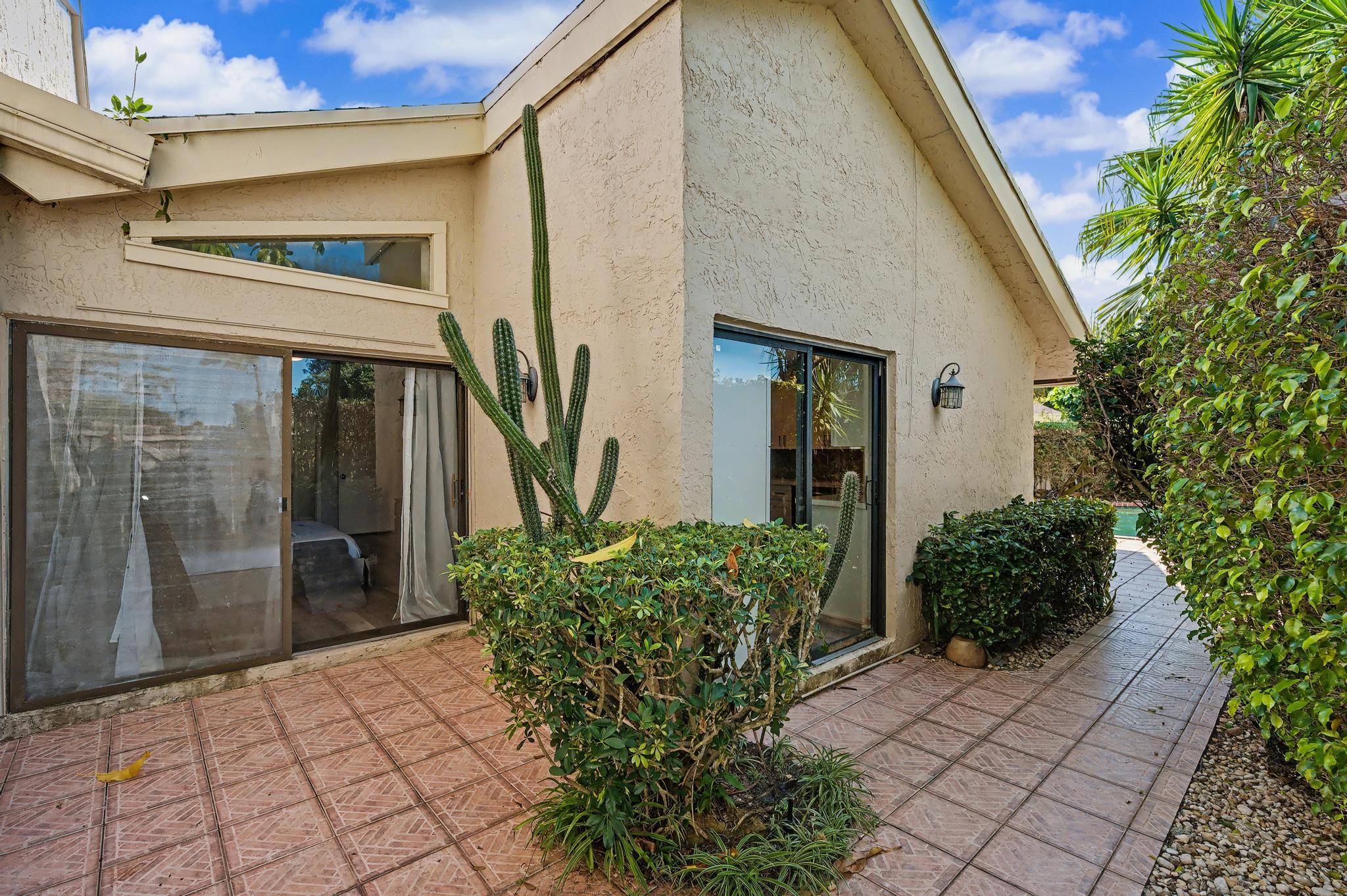 7855 Stanway Place Boca Raton, FL 33433 - Photo 21 of 25 a couple of potted plants in front of door