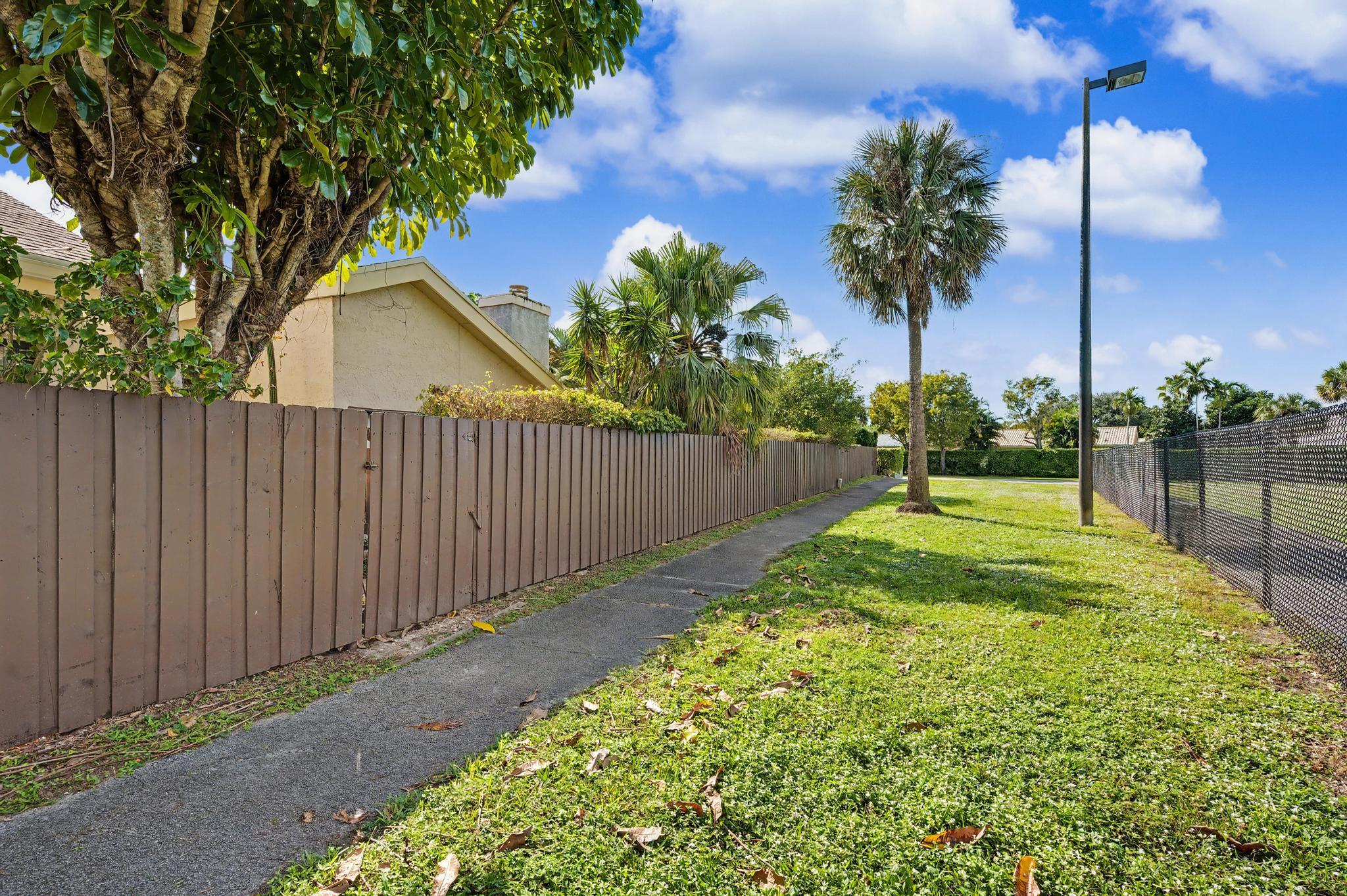 7855 Stanway Place Boca Raton, FL 33433 - Photo 22 of 25 a view of a backyard with a tree