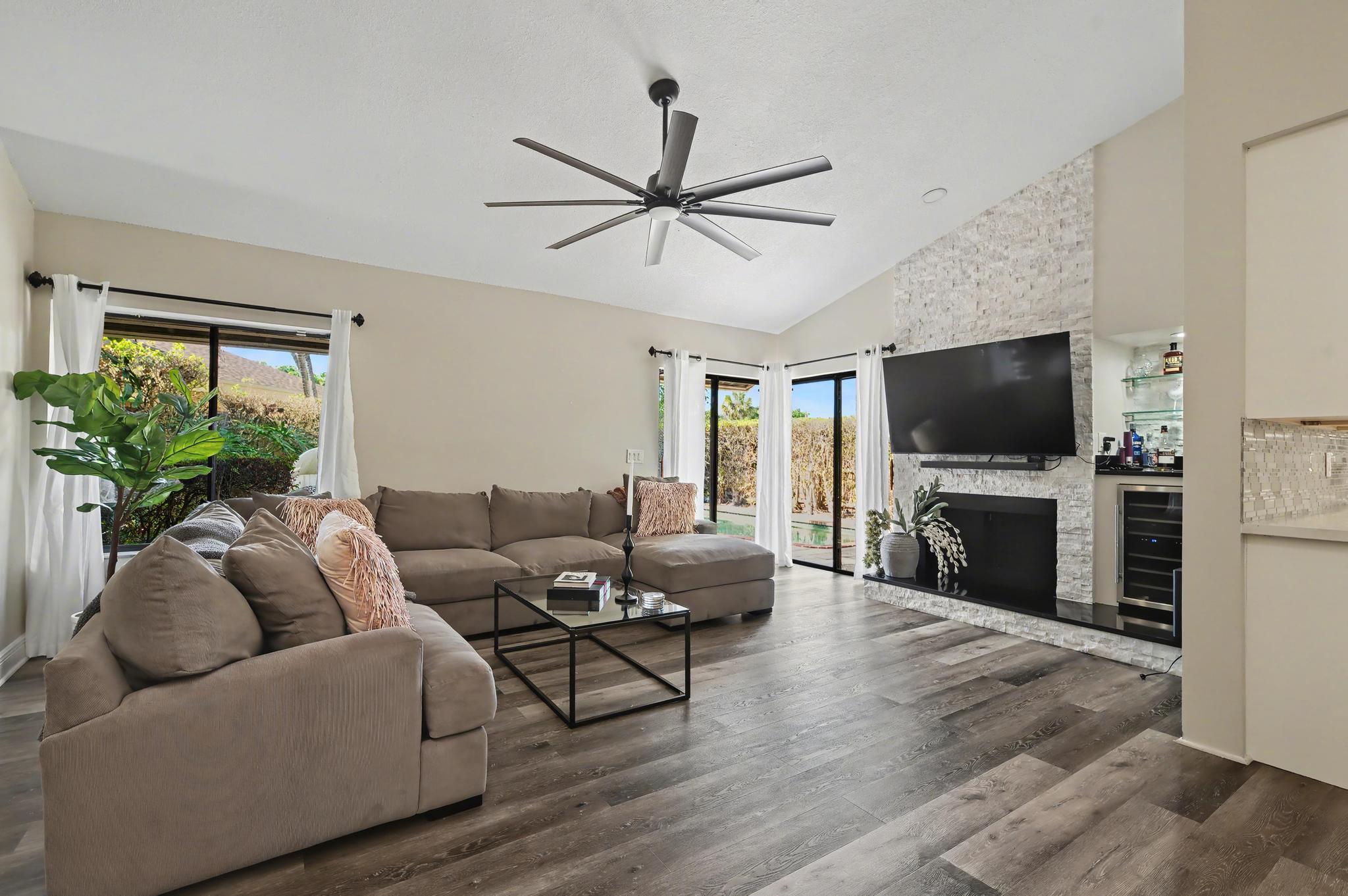 7855 Stanway Place Boca Raton, FL 33433 - Photo 7 of 25 a living room with furniture a flat screen tv and a fireplace