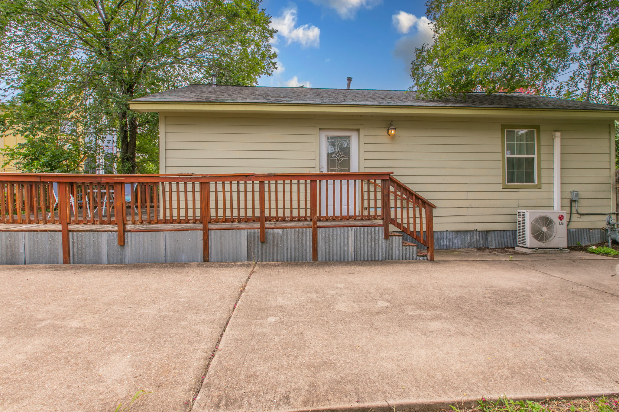 1107 Vargas Road Austin, TX 78741 - Photo 13 of 17 A welcoming rear facade features a raised wooden deck with convenient stair access to the paved patio.