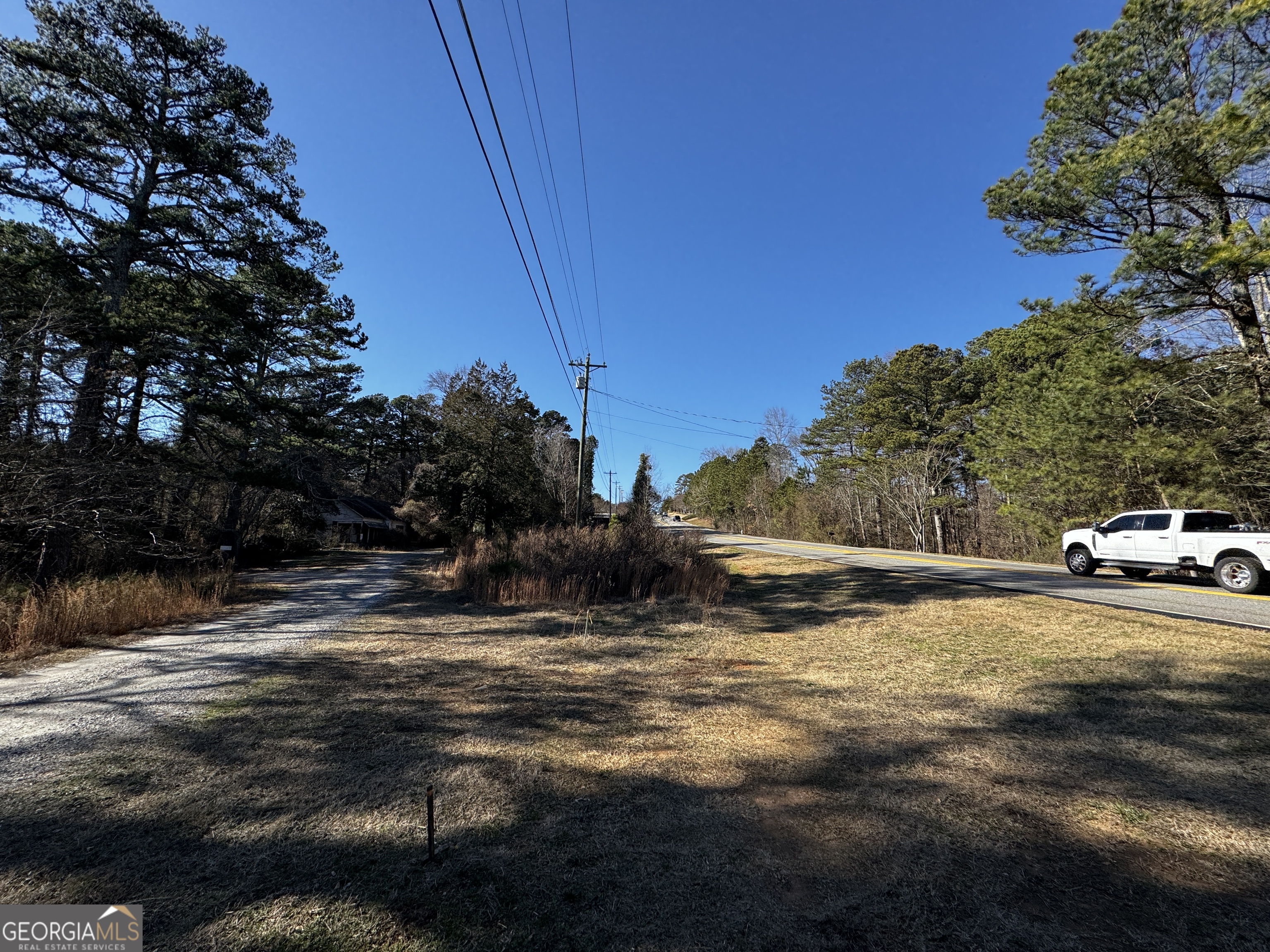 1740 Buford Dam Road Cumming, GA 30041 - Photo 16 of 17 a view of dirt yard with a large tree