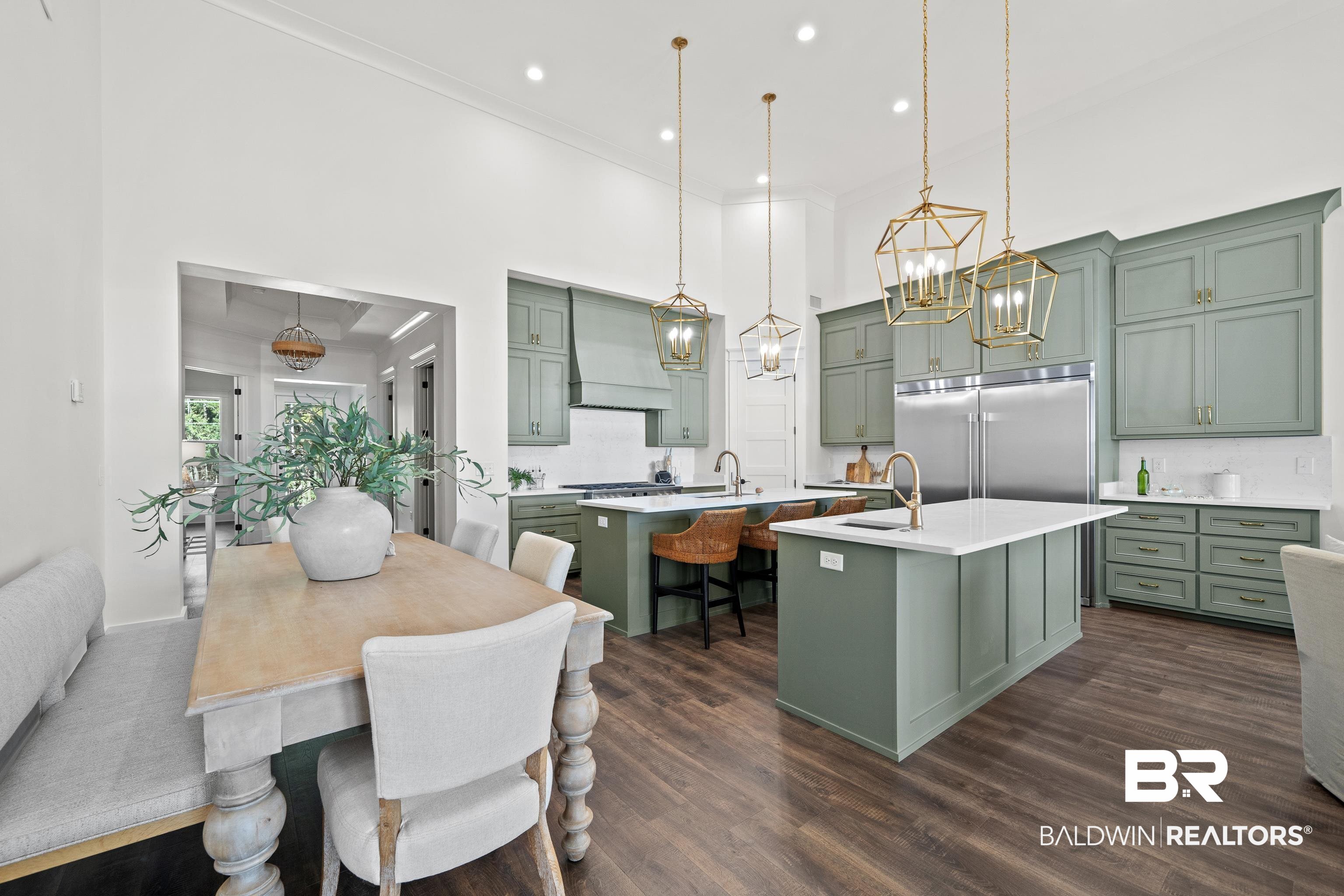 12453 County Road 1 Fairhope, AL 36532 - Photo 4 of 33 Kitchen featuring dark wood-type flooring, stainless steel appliances, green cabinets, a kitchen island with sink, and custom exhaust hood