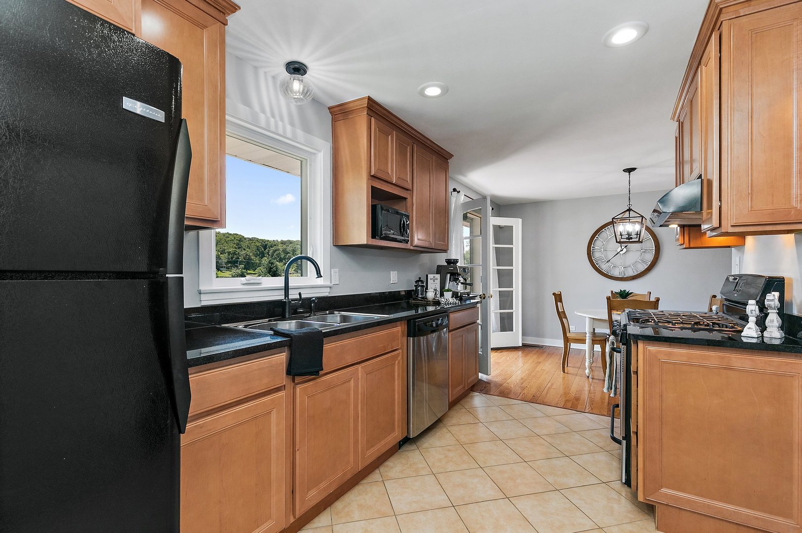 1037 North Harrison Street Algonquin, IL 60102 - Photo 11 of 46 a kitchen with stainless steel appliances granite countertop a sink a stove a refrigerator a microwave oven with cabinets and wooden floor