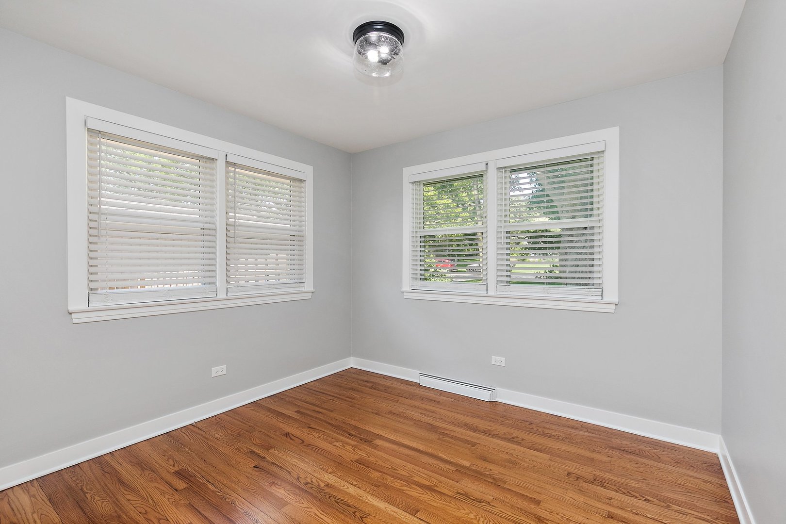 1037 North Harrison Street Algonquin, IL 60102 - Photo 20 of 46 a view of an empty room with wooden floor and a window