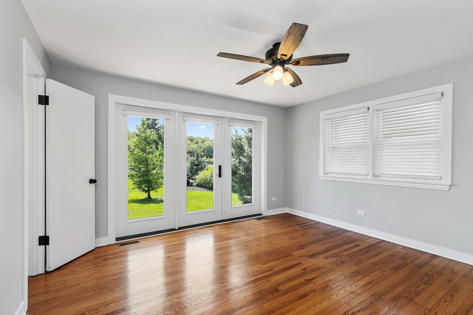 1037 North Harrison Street Algonquin, IL 60102 - Photo 21 of 46 a view of an empty room with window and wooden floor