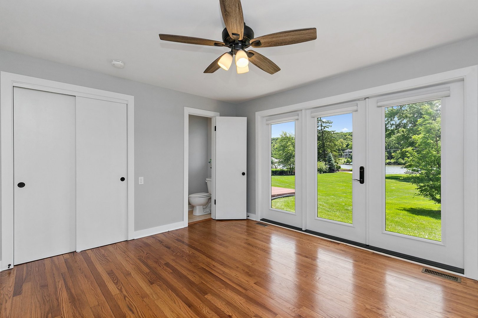 1037 North Harrison Street Algonquin, IL 60102 - Photo 22 of 46 a view of an empty room with window wooden floor and a ceiling fan
