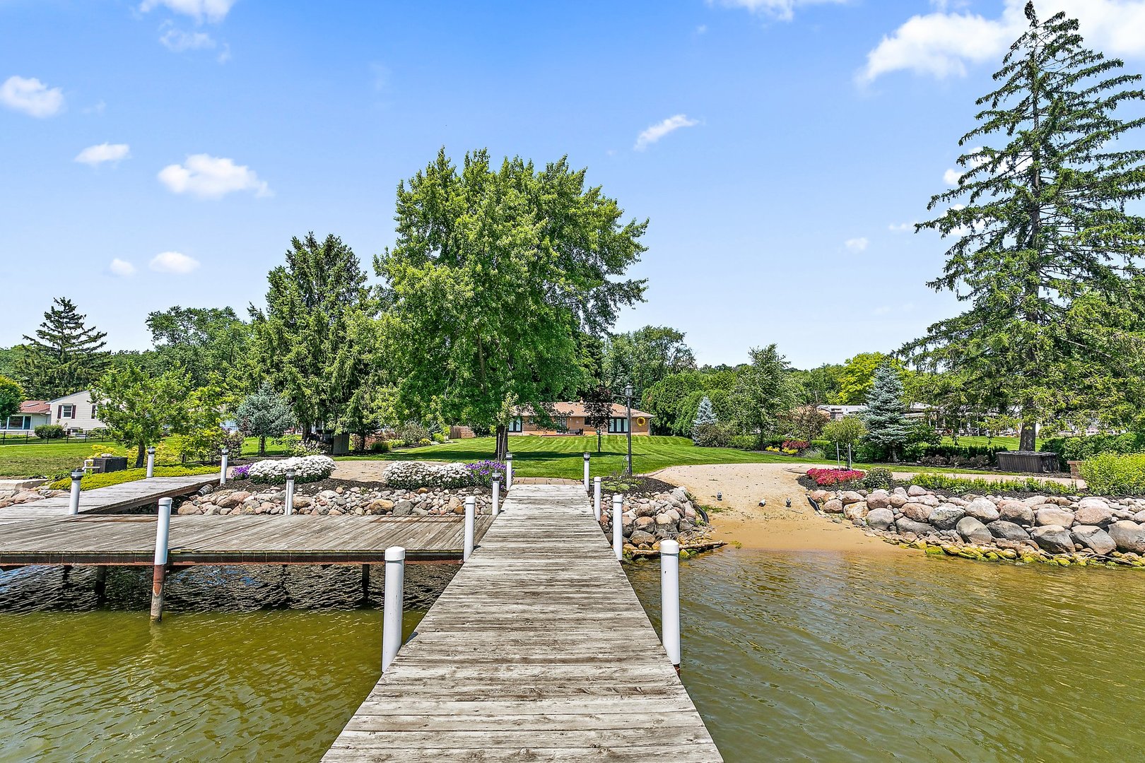 1037 North Harrison Street Algonquin, IL 60102 - Photo 30 of 46 a view of an ocean with swimming pool and trees in the background