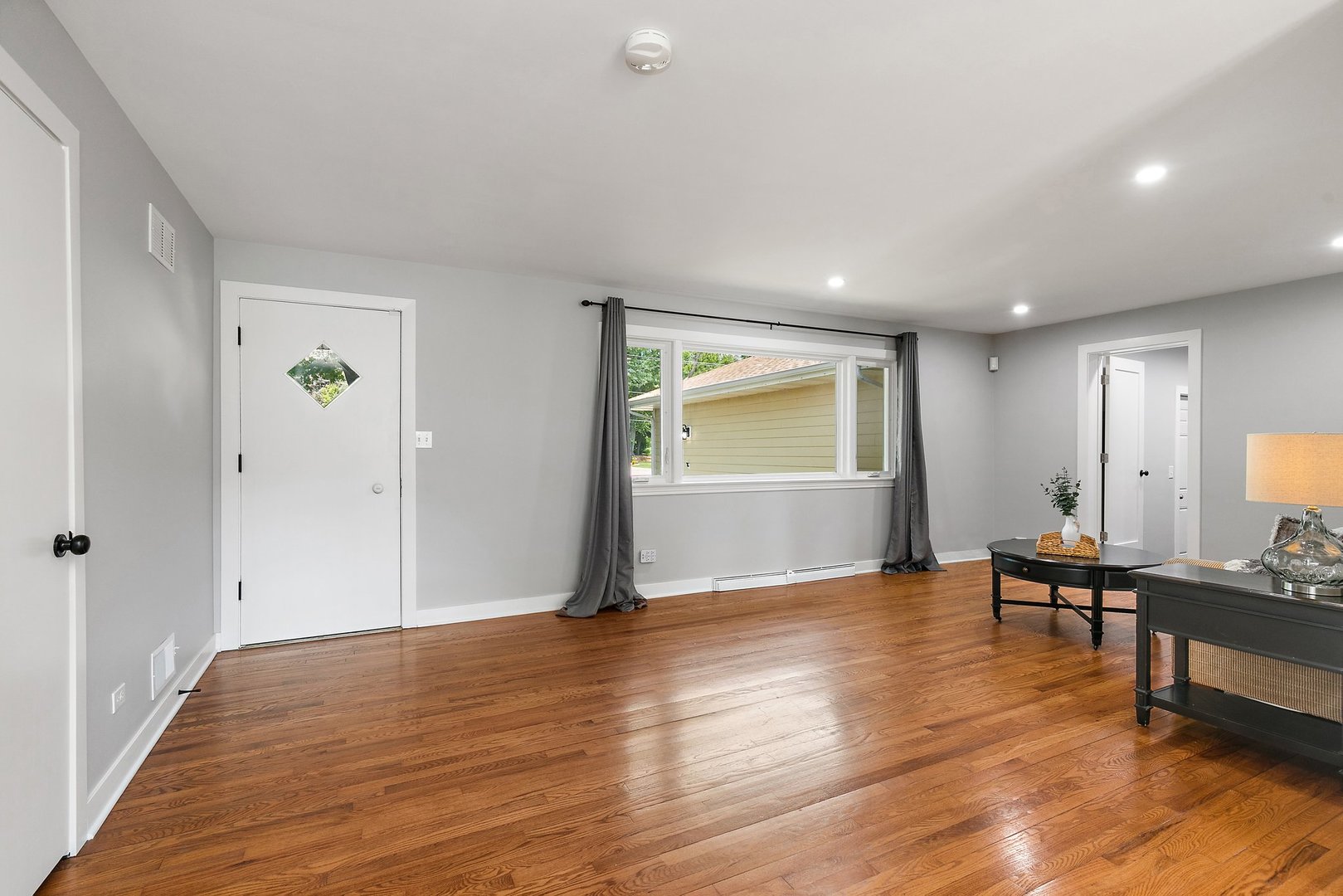 1037 North Harrison Street Algonquin, IL 60102 - Photo 3 of 46 a view of an empty room with wooden floor and a window