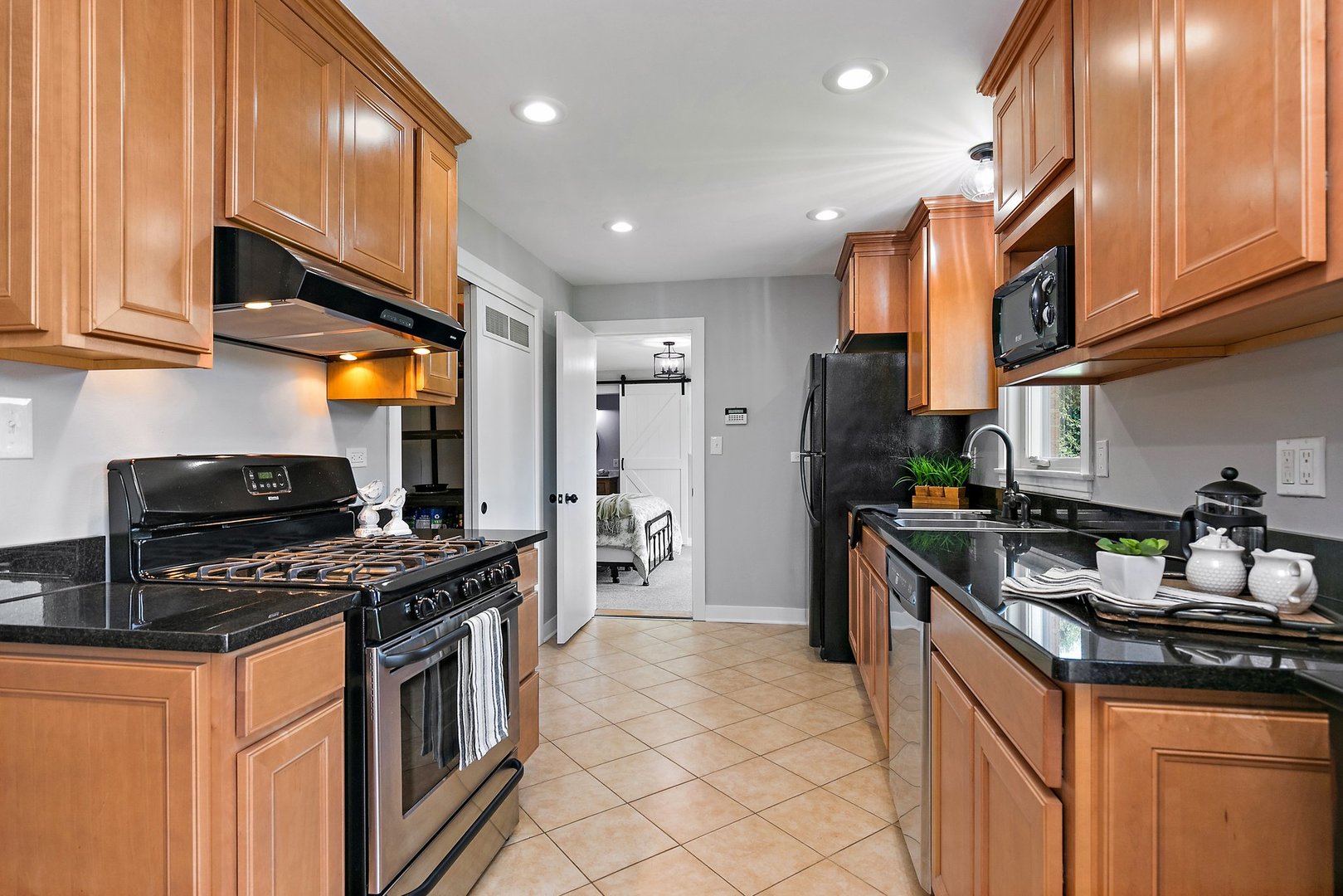1037 North Harrison Street Algonquin, IL 60102 - Photo 7 of 46 a kitchen with stainless steel appliances granite countertop a stove a sink and a refrigerator