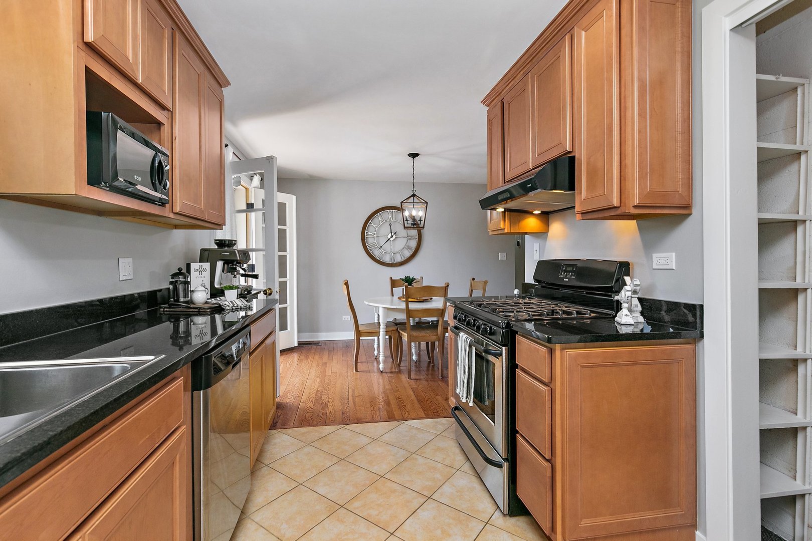 1037 North Harrison Street Algonquin, IL 60102 - Photo 9 of 46 a kitchen with stainless steel appliances granite countertop a stove and a sink