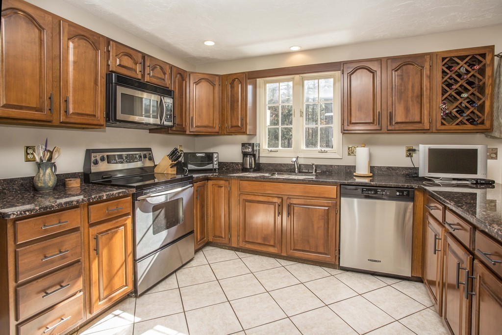 15 Virginia Ridge Road Sudbury, MA 01776 - Photo 2 of 16 a kitchen with stainless steel appliances granite countertop a stove sink and cabinets