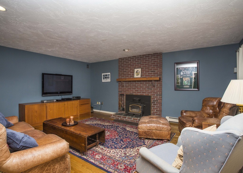 15 Virginia Ridge Road Sudbury, MA 01776 - Photo 5 of 16 a living room with furniture and a fireplace