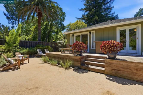 a view of a house with backyard and sitting area