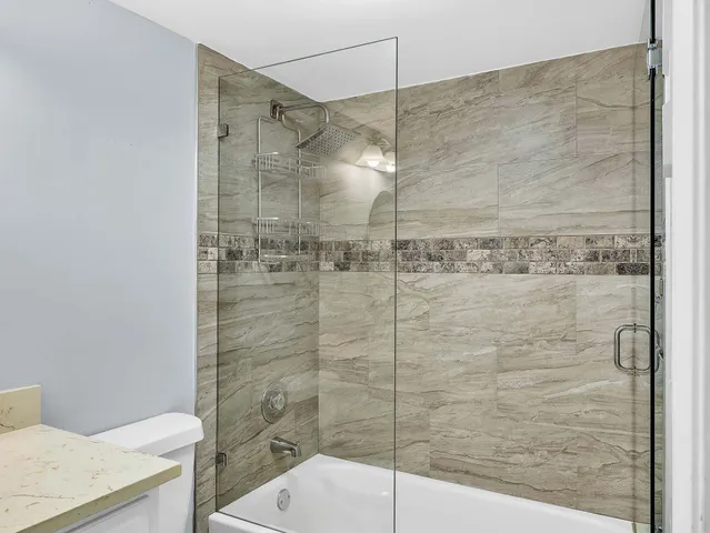 a bathroom with a toilet and a shower