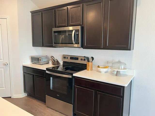 a kitchen with a sink stove and microwave