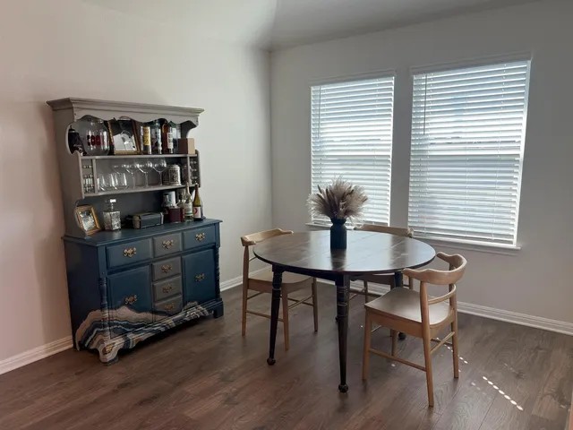 a room that has a table and a chair in it