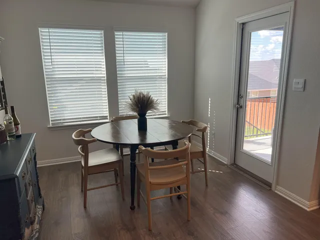 a view of a dining room with furniture and wooden floor