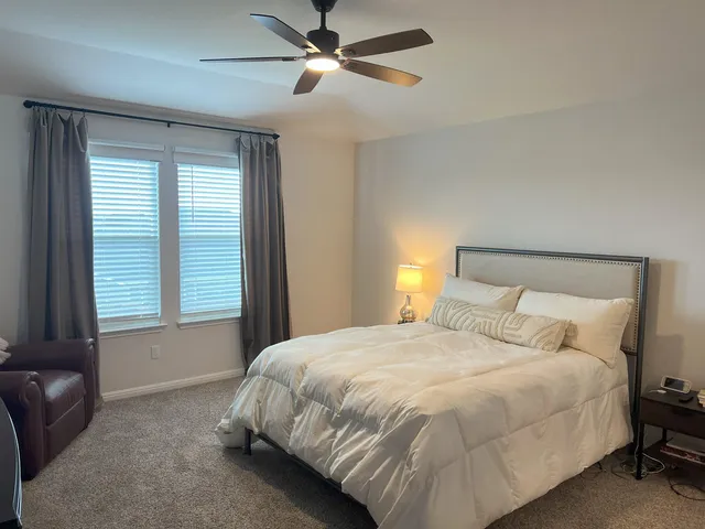 a bedroom with a bed and window