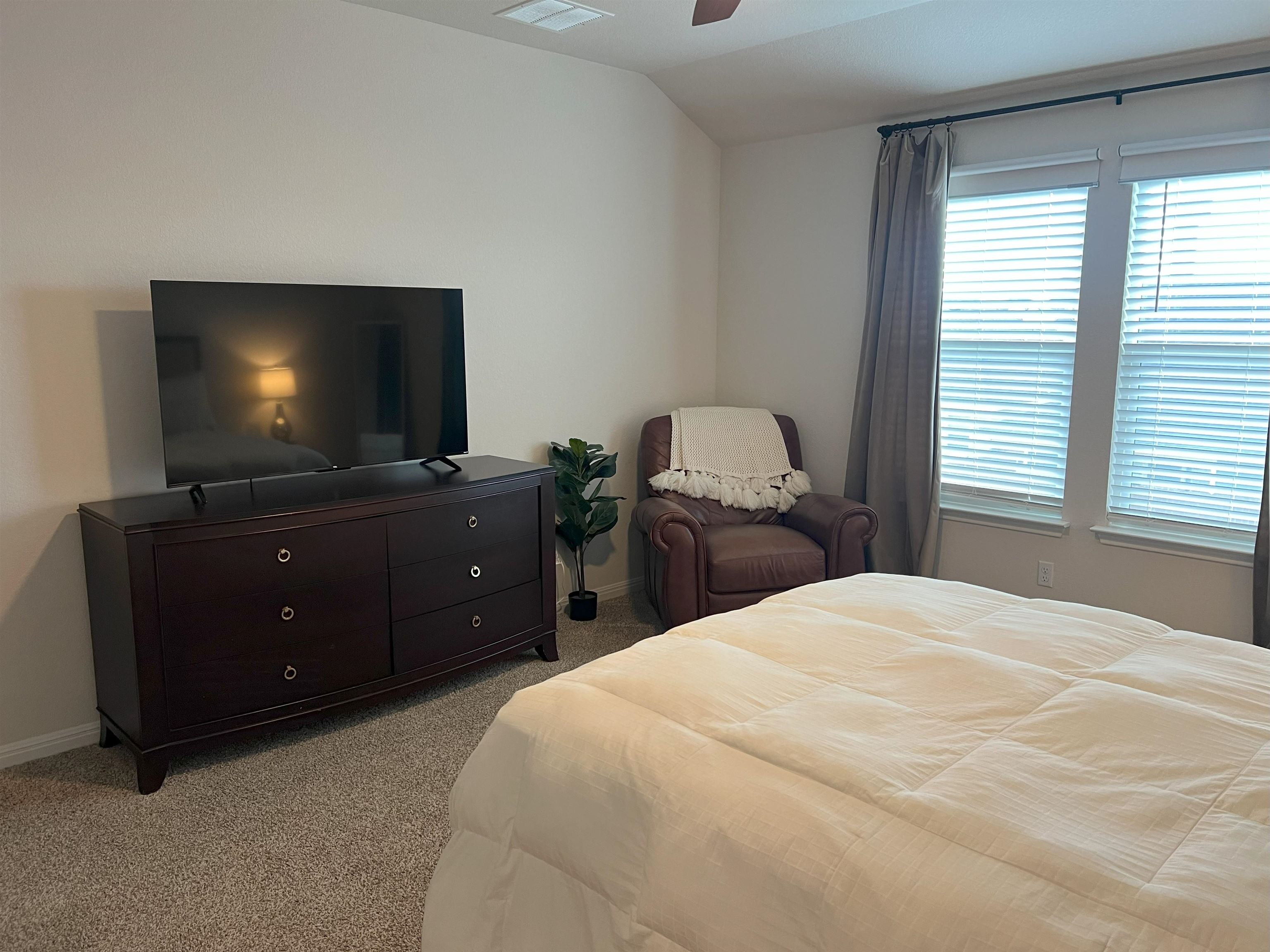 248 Lone Cedar Road Marble Falls, TX 78654 - Photo 20 of 30 a bedroom with a bed and a flat screen tv