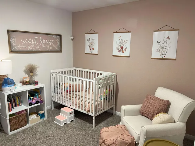 a bedroom with furniture and a baby crib