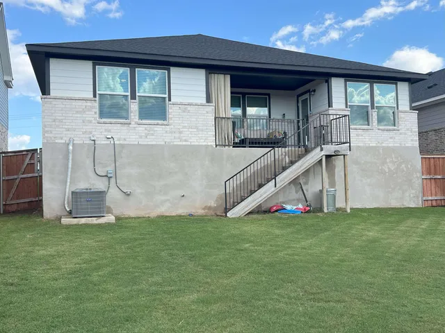 a view of front of house with a yard