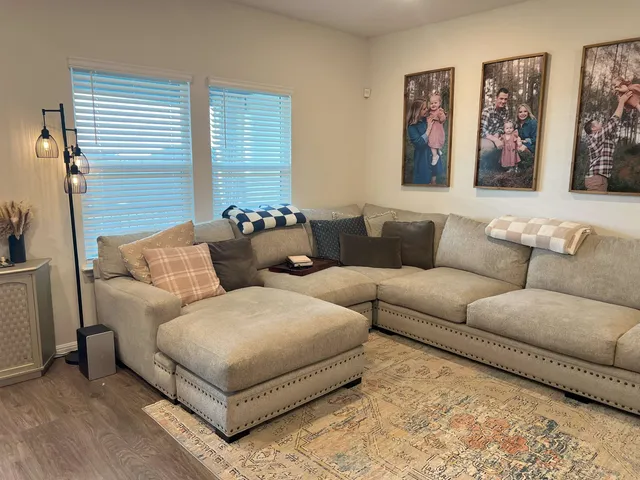 a living room with furniture and a night stand