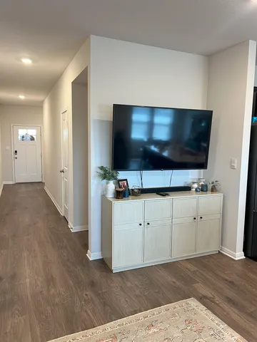 a living room with flat screen tv cabinet and a flat screen tv