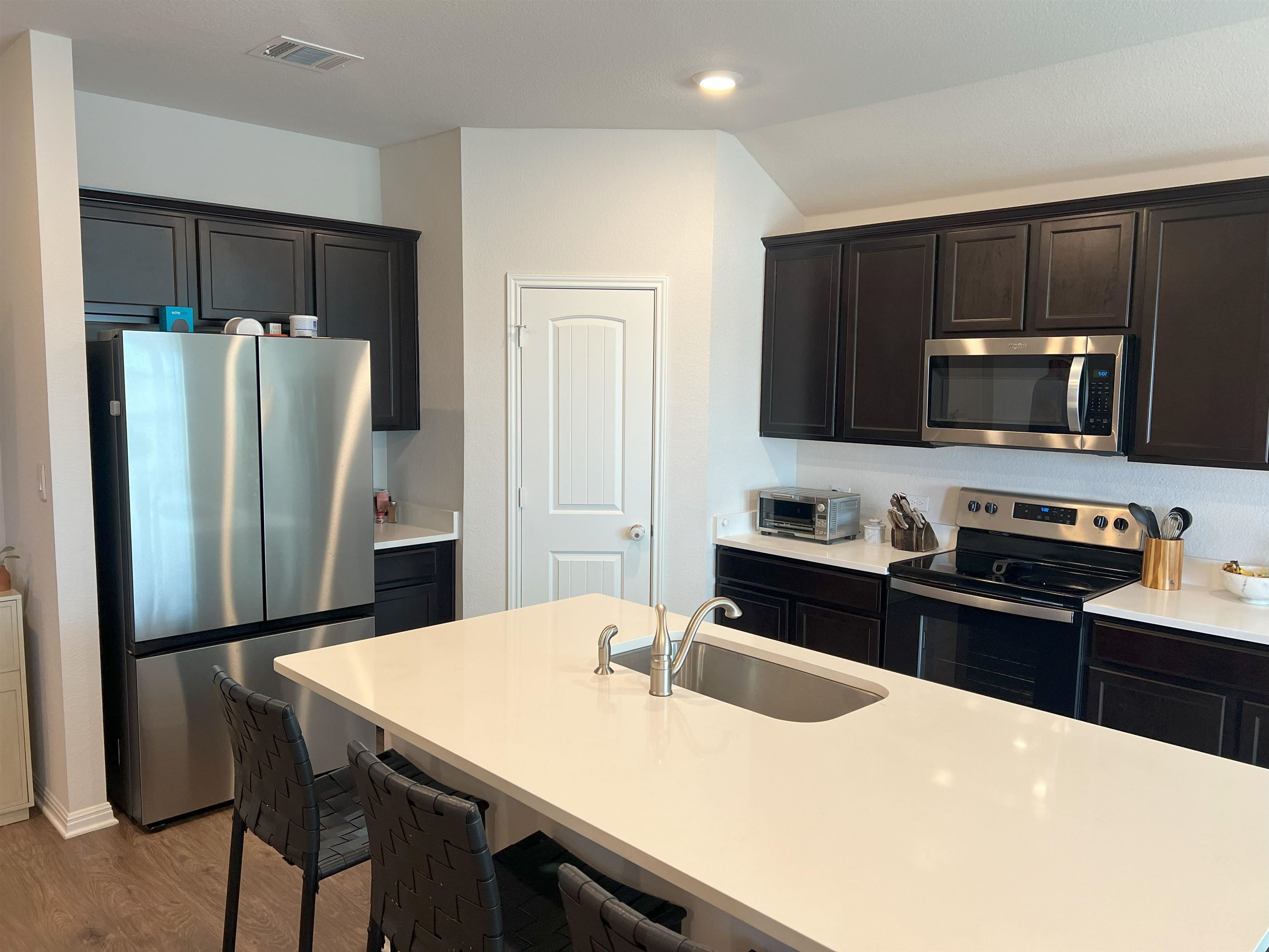 248 Lone Cedar Road Marble Falls, TX 78654 - Photo 10 of 30 a kitchen with stainless steel appliances a refrigerator stove microwave and sink