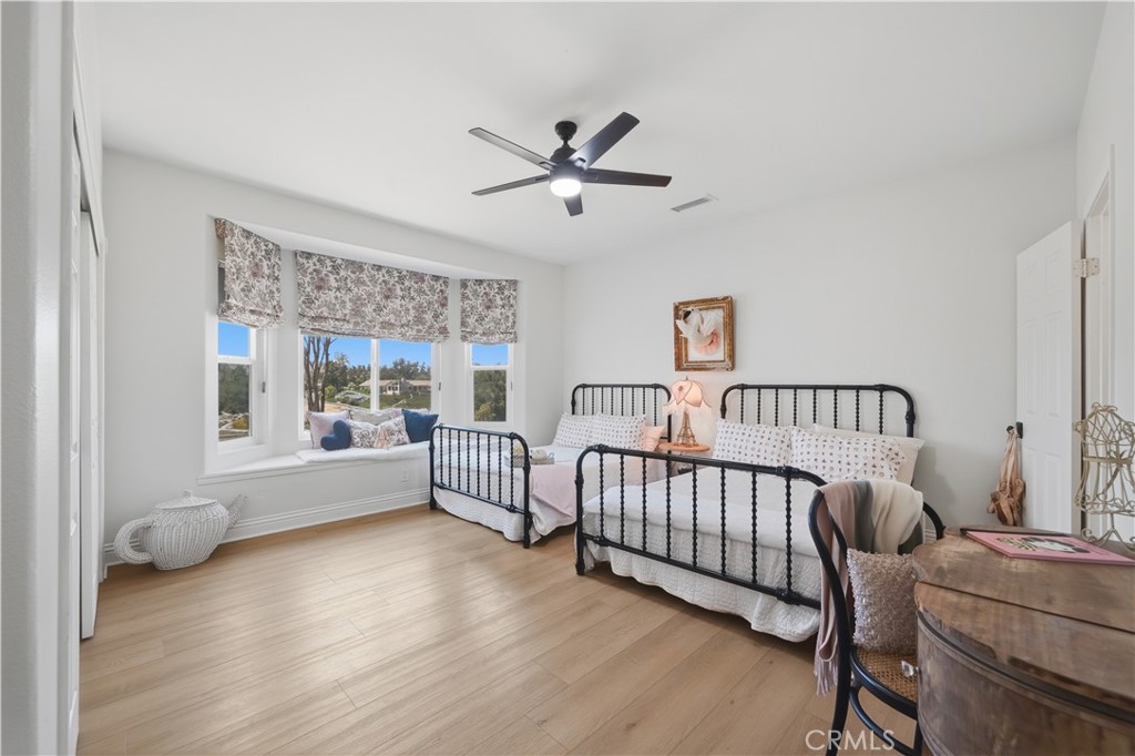 41110 Los Ranchos Circle Temecula, CA 92592 - Photo 38 of 77 a view of a bedroom with furniture and wooden floor