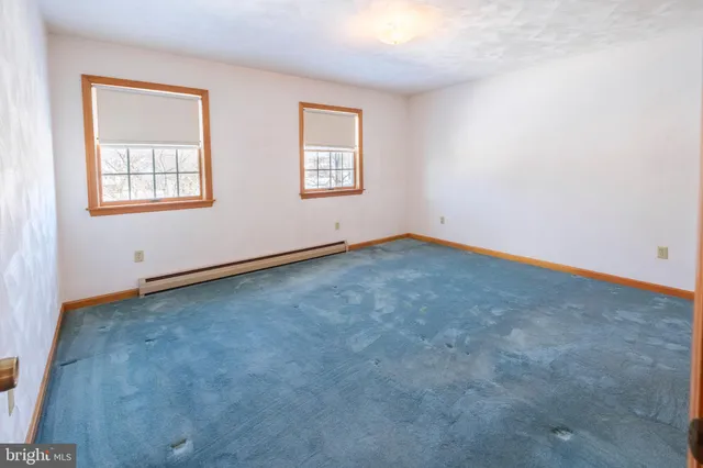 a view of a room with a door and a window