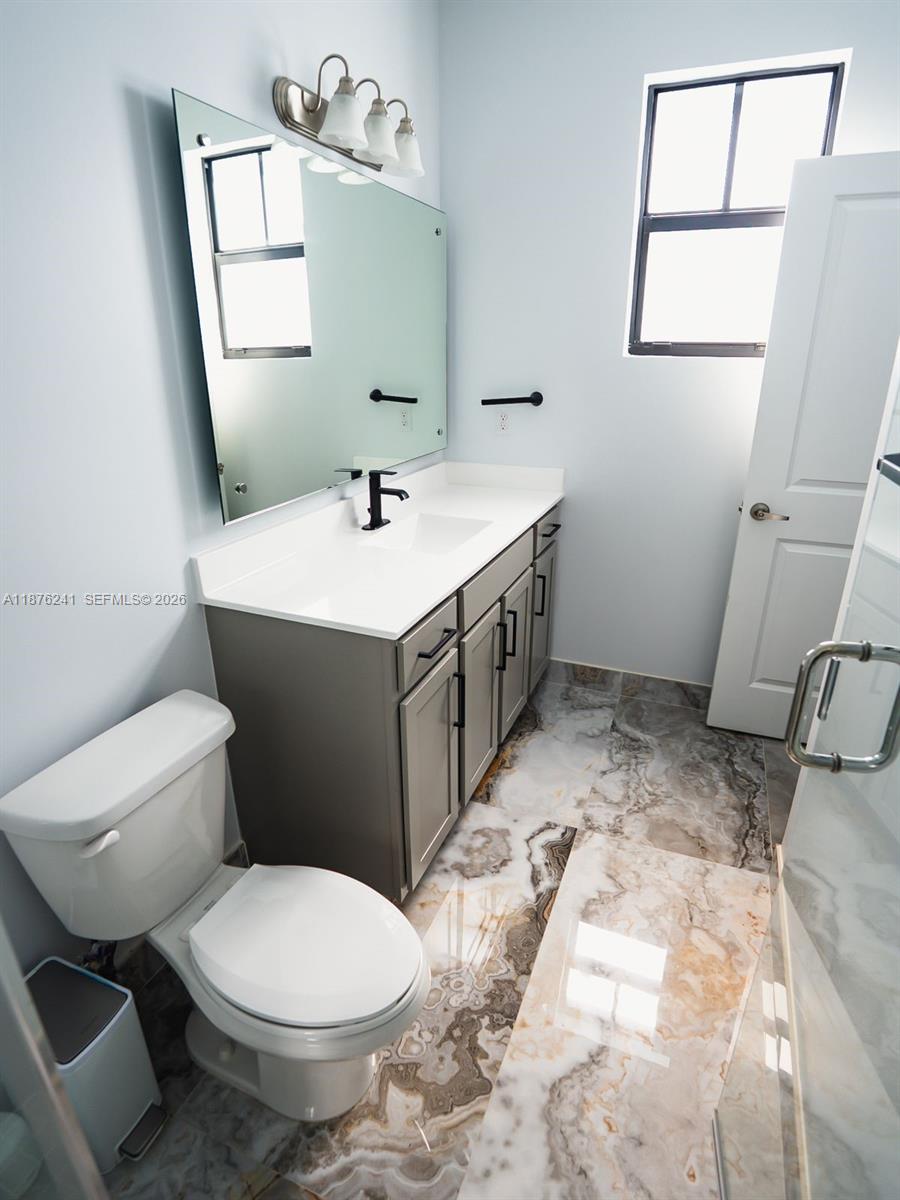 14478 Southwest 21st Street Miami, FL 33175 - Photo 17 of 42 a bathroom with a sink toilet and mirror