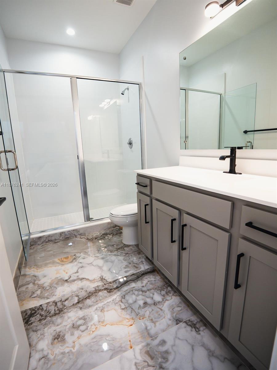 14478 Southwest 21st Street Miami, FL 33175 - Photo 19 of 42 a bathroom with a sink a toilet and a shower