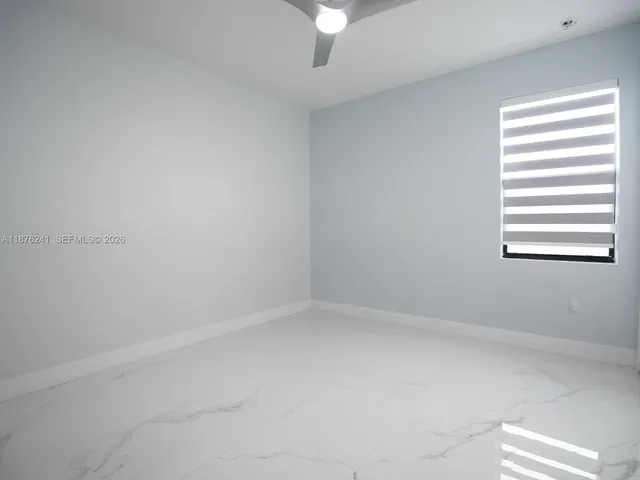a kitchen with granite countertop white cabinets and stainless steel appliances