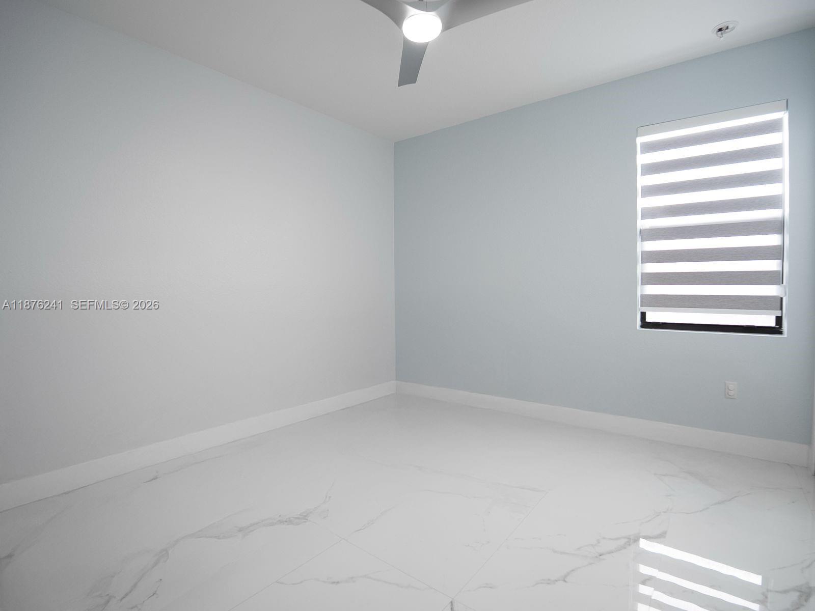 14478 Southwest 21st Street Miami, FL 33175 - Photo 20 of 42 a view of an empty room with a window