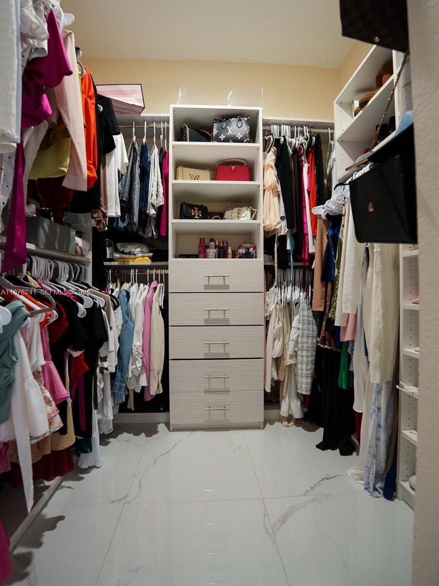 14478 Southwest 21st Street Miami, FL 33175 - Photo 25 of 42 a view of walk in closet with clothes and shoes