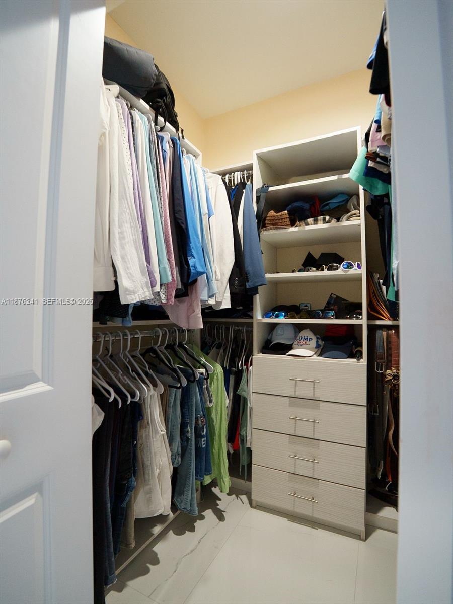 14478 Southwest 21st Street Miami, FL 33175 - Photo 27 of 42 a view of walk in closet with clothes and shoes